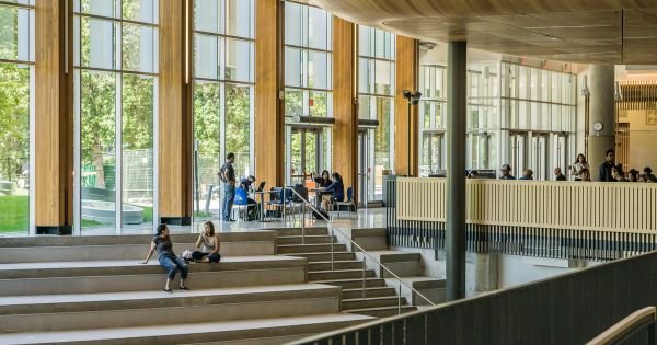 Group of Indian students outside an American university, worried about international student cap and higher education reforms.
